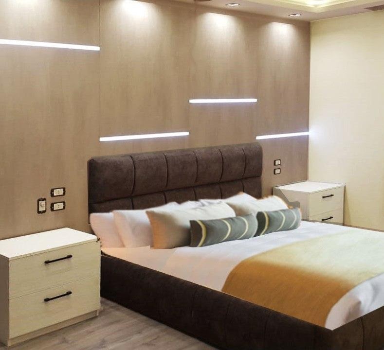 Bedroom with upholstered bed and floating nightstands